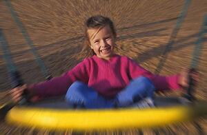 Young girl on playground ride
