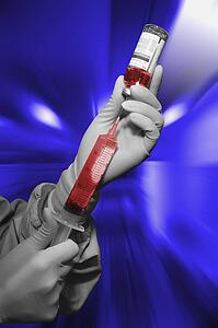 Medical personnel drawing drugs for an injection