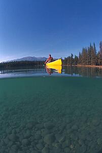 Man in yellow canoe on lake