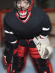 Young hockey goalie in net