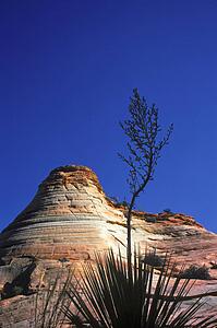 Rock hill with striations and blue sky