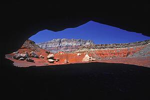 View of desert canyon from large cave