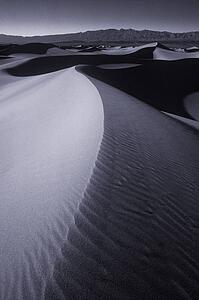 Ripples in desert sand with mountain in background