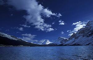 Snow-covered mountains across lake