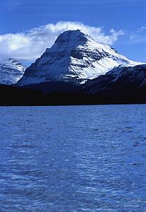 Snow-covered mountains across lake