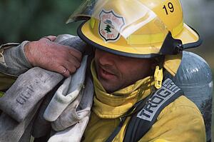 Fireman carrying hose