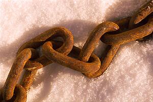 Rusted link chain on snow