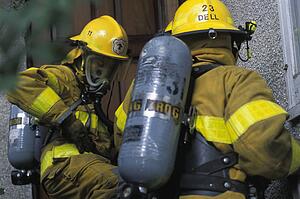 Firemen with masks outside building