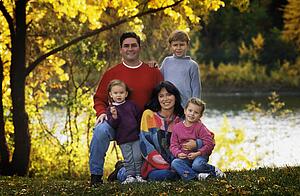 Portrait of family in park by river