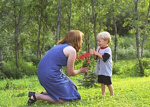 Mother and son with flowers in park