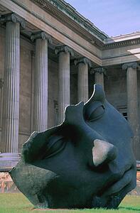 Large sculpture of face in colonnaded courtyard