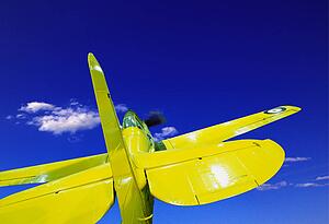 Small yellow single-seat airplane