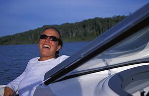 Woman laughing on front of speedboat