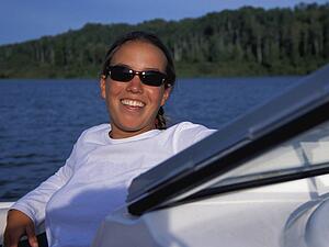 Woman laughing on front of speedboat