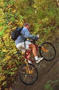 Man riding trail bike in forest