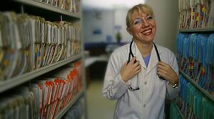 Doctor standing beside patient records