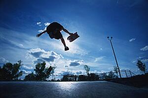 Skateboarder jumping in skate park