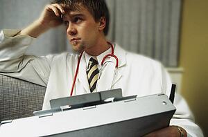 Doctor on couch with patient history binder