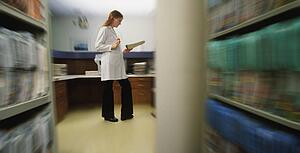 Doctor or nurse reading patient record