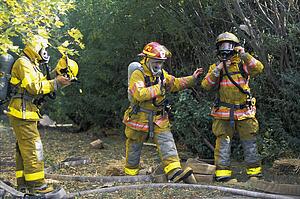 Firemen putting on equipment