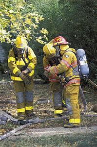 Firemen putting on equipment