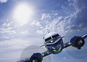 Head-on view of twin engine propeller airplane