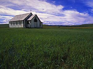 Small country church in grass field
