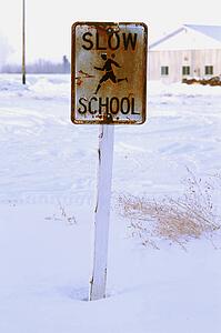 Rusty school zone sign in winter