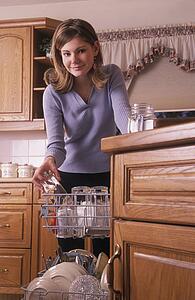 Girl loading dishwasher