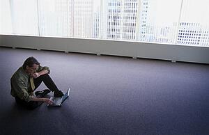 Man on floor of empty office