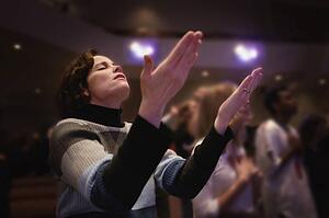 Woman with upraised hands