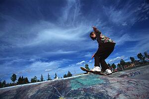 Boarder performing stunt at skate park