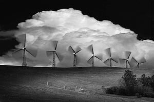 Black and white of wind generators with cloud in background