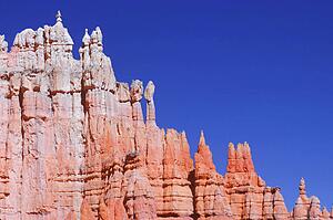 Edge of red rock canyon with blue sky background.