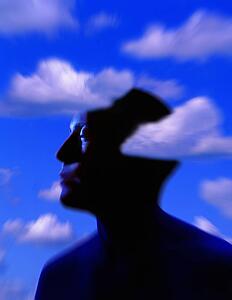 Silhouette of man's head with cloud background