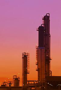 Refinery towers at sunset