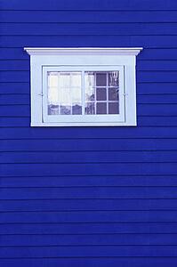 White window on blue siding