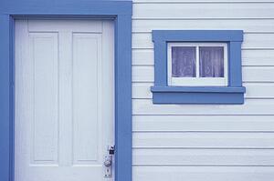 White door and window on white siding with blue trim