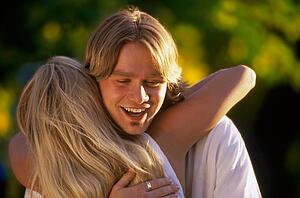 Teen couple hugging