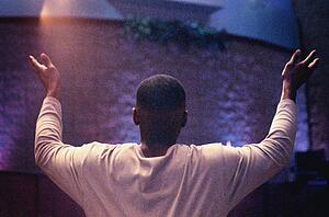 Man with hands raised in worship