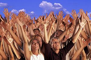 Many hands raised in worship