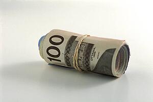 Roll of money with a hundred on outside