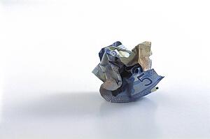 Crumpled five dollar bill
