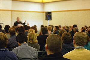 People asking questions in a meeting