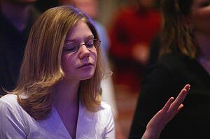 Woman raising hand in worship