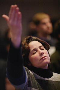 Woman raising hand in worship