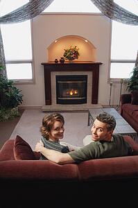 Couple relaxing in front of fire