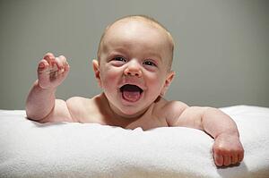 Laughing baby lying on tummy