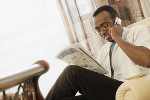 Man reading the newspaper at home
