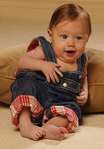 Baby reclining in overalls